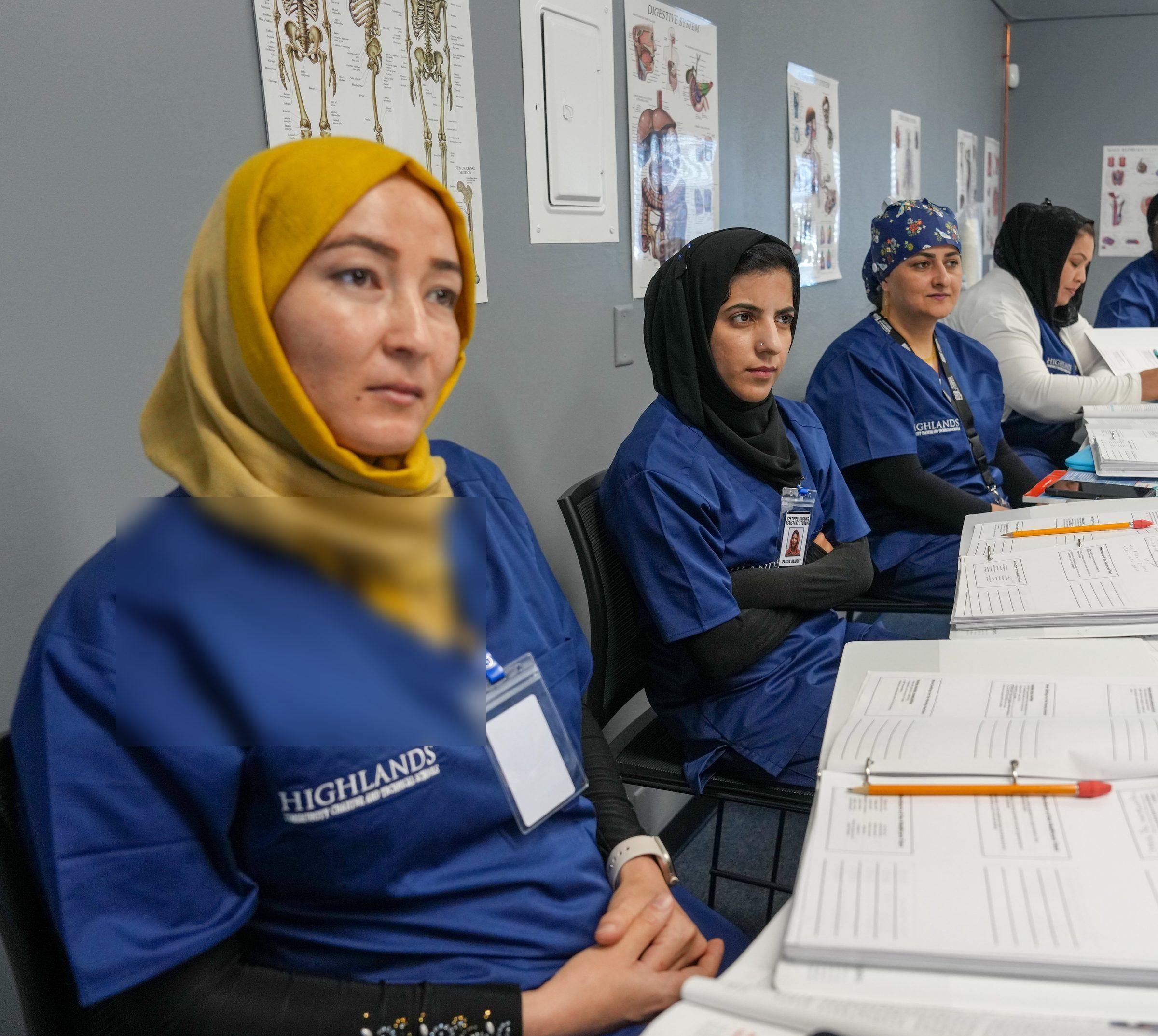A row of community members in Highlands scrubs seated together in a Career Technical Education health classroom.